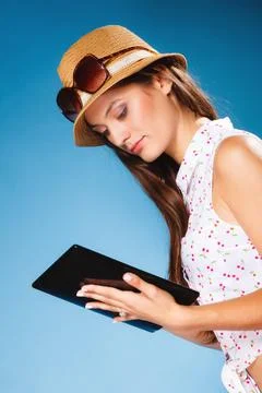 Girl using tablet computer e-book reader. Stock Photos