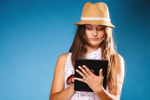 Girl using tablet computer e-book reader. Stock Photos