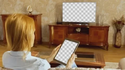 Girl Using Tablet In Front Of The TV 1 With Isolated Screen Stock Footage 58751891