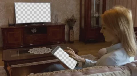 Girl Using Tablet In Front Of The TV 2 With Isolated Screen Stock Footage 58757890