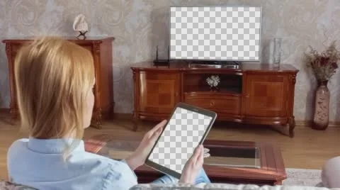 Girl Using Tablet In Front Of The TV With Isolated Screen 1 Stock Footage 64700336