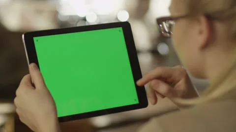 Girl Using Tablet with Green Screen in Landscape Mode in Coffee Shop Stock Footage