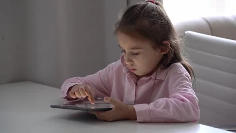 Girl Using Tablet. Intensely focused on a gadget Stock Footage 275646811