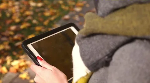 Girl using tablet pc. Autumn time. Close up. Stock Footage 56547776