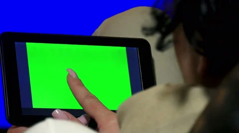 Girl Using Tablet PC with Green Screen. 4K UHD stock video, alpha luma matte Stock Footage 46751031