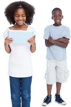 Girl using tablet pc with her brother behind her Stock Photos