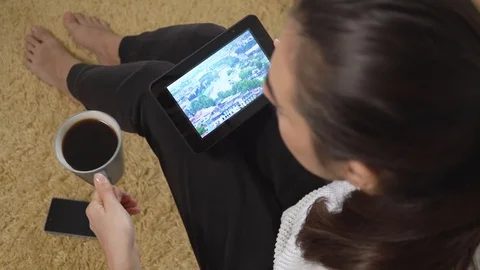 Girl using tablet pc for watching nature and vacation video on screen while Stock-Footage 97894793