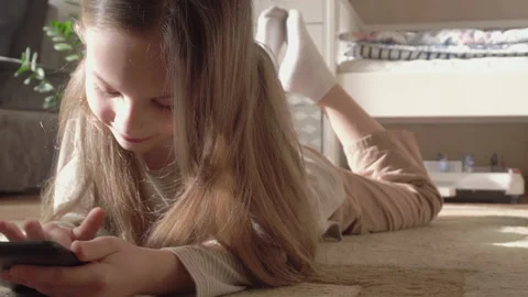 Girl using a tablet to play Video stock 170383754