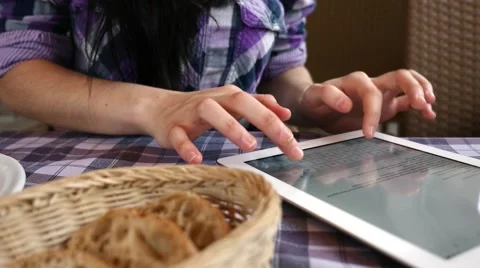 Girl using tablet in the restaurant. She just finished her breakfast.  Close up Stock Footage 61408307