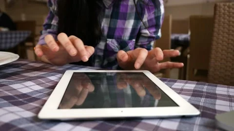 Girl using tablet in the restaurant. She just finished her breakfast.  Close up. Stock Footage 61408383
