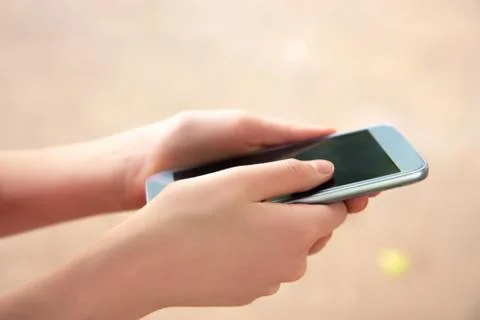 Girl using a touch screen of smart phone Stock Photos