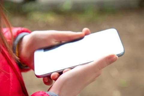Girl using a touch screen of smart phone on outside Stock Photos