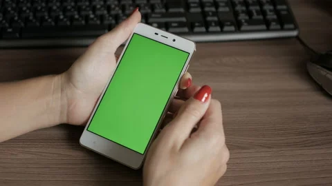 Girl Using Touchscreen Mobile Phone. Young Woman Home Sitting at Table with G Video stock 117683518