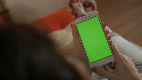 Girl Using Touchscreen Mobile Phone. Young Woman Home Lying on a Couch with G Stock Footage 117685084