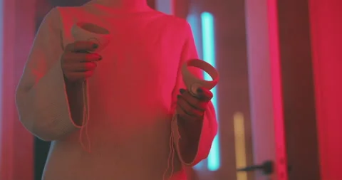 A girl using the virtual reality controller in magenta neon light Stock Footage 201110692