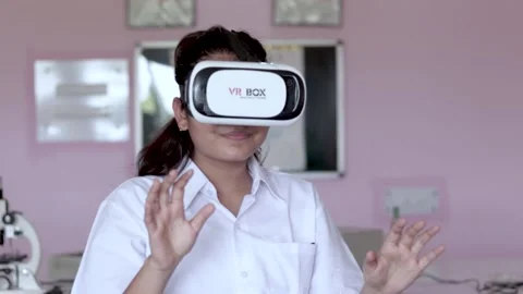 A Girl Is using  In Virtual Reality Glasses. Futuristic Education Concept. Stock Footage 157057583