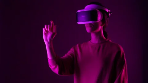 Girl using virtual reality headset. Female in VR glasses, neon light backgraund Stock Footage 164996833