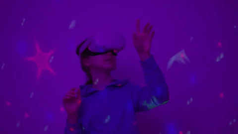 Girl Using Virtual Reality Headset And Looking Around At Interactive Techno.. Stock Footage 346083863