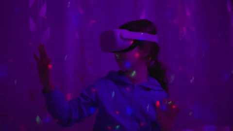 Girl Using Virtual Reality Headset And Looking Around At Interactive Techno.. Stock Footage 346084255