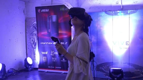 Girl using virtual reality HTC game development kit, virtual reality glasses in Stock Footage 83221985