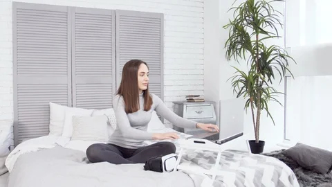 Girl using VR glasses in front of laptop Stock Footage 88155985