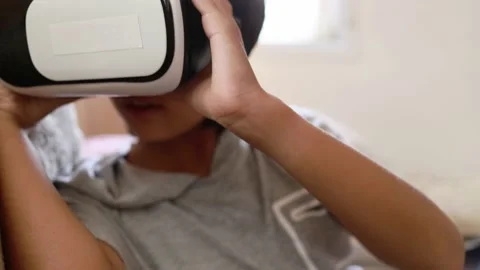 Girl using VR goggle playing watching internet content Stock Footage 188658707