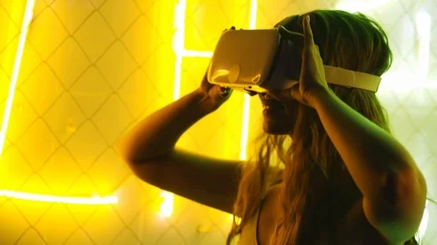 Girl using VR goggles in neon lights Stock Footage 123153852