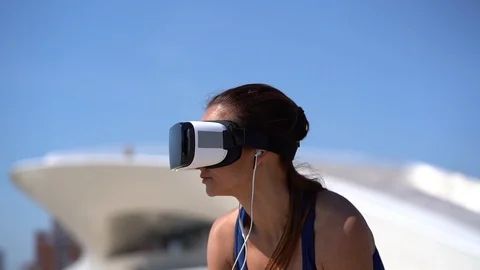 Girl using vr headset against blue sky Stock Footage 105007190