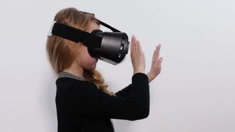 Girl using VR moving around. Girl revolves around itself in an imaginary indoor Video stock 73023145