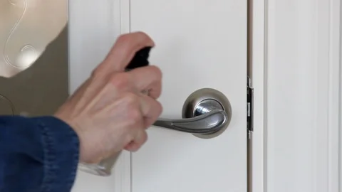 Girl Using Wet Wipe And Alcohol Sanitizer Spray for Disinfect Door Handle Stock Footage 129293178
