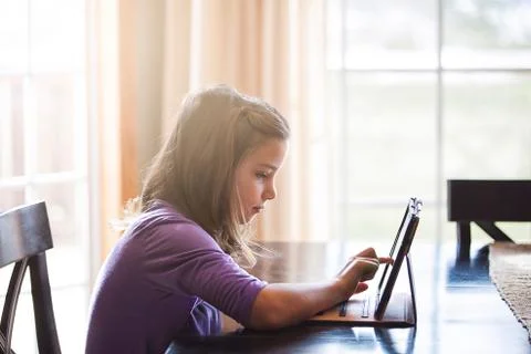 Girl using wireless digital tablet at home Stock Photos