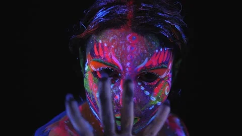 A girl with a UV pattern on her face. Model posing with UV pattern on body. Stock Footage 221341778