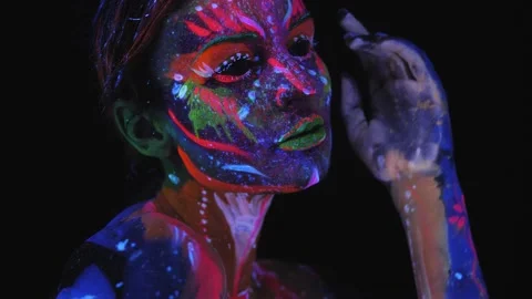 A girl with a UV pattern on her face. Model posing with UV pattern on body. Stock Footage 221433736