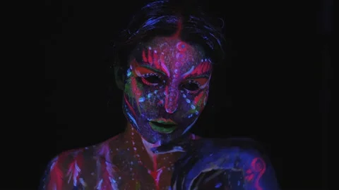 A girl with a UV pattern on her face. Model posing with UV pattern on body. Stock Footage 221486676