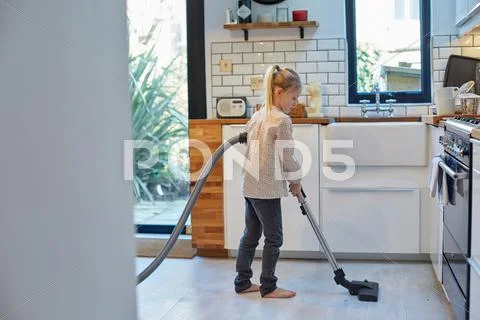 Girl Vacuuming Kitchen Floor