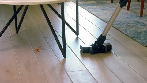 Girl vacuuming under the table Stock Footage 150705222