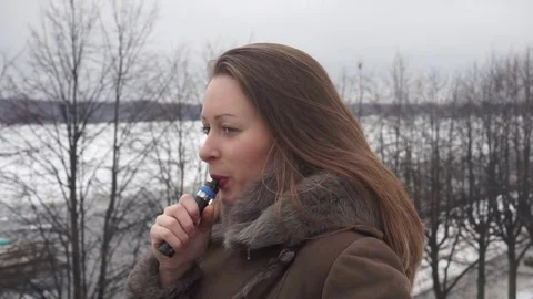 Girl vaping outside Stock Footage 74671616