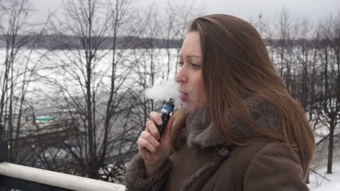 Girl vaping outside Stock Footage 74671626