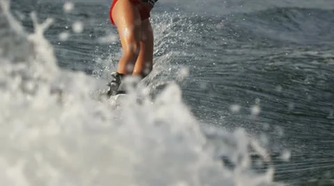 Girl on a wakeboard behind a boat Stock Footage