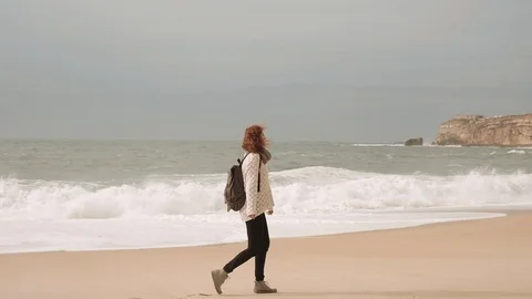 Girl Walking Alone On Empty Seashore In Cloudy Cold Weather. Stock-Footage 107722128