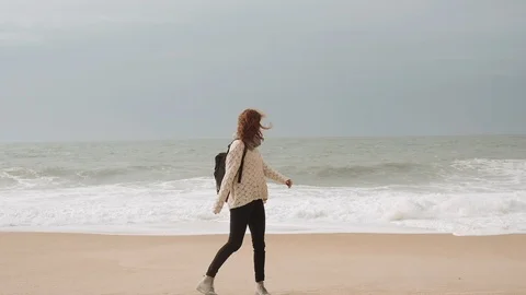 Girl Walking Alone On Empty Seashore In Cloudy Cold Weather. Video stock 107722167