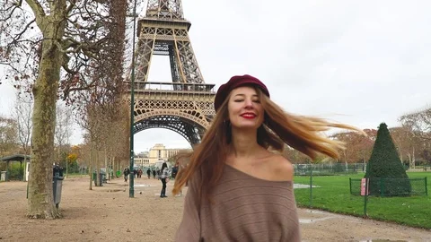 Girl walking and smiling on the Eiffel tower background Stock Footage 101530939