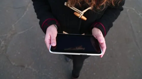 Girl is Walking and Using a Tablet Stock Footage 56302268