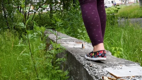 Girl walking on the construction site among the green grass Video stock 113895953