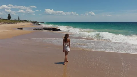 Girl walking on a deserted beach Stock Footage 244635802