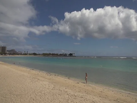 Girl Walking Down Long Beach Towards Honolulu Hawaii Stock Footage 80072443