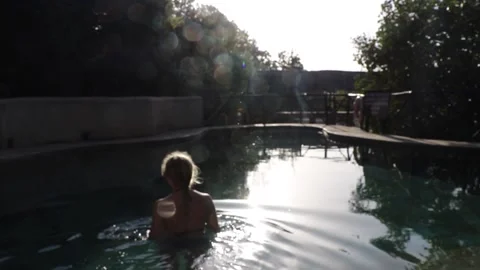 Girl walking down into pool Stock Footage 170255205