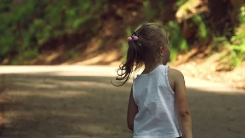 Girl walking in a forest clearing. Stock Footage 253180181
