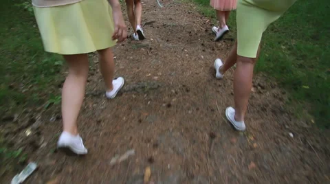 Girl walking on a forest path. Slender legs. White sneakers. Forest Trail. Walk Stock Footage 61714671