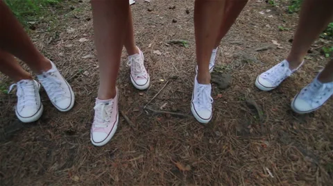 Girl walking on a forest path. Slender legs. White sneakers. Forest Trail. Walk Stock Footage 61714792